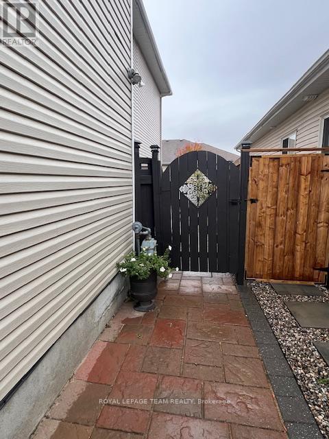 A black gate with a diamond pattern in the middle is closed.