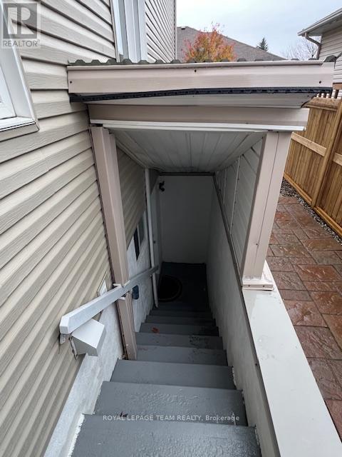 A stairway leading to a door under a porch.