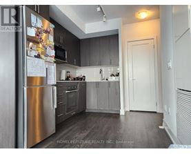 A kitchen with a refrigerator covered in papers.