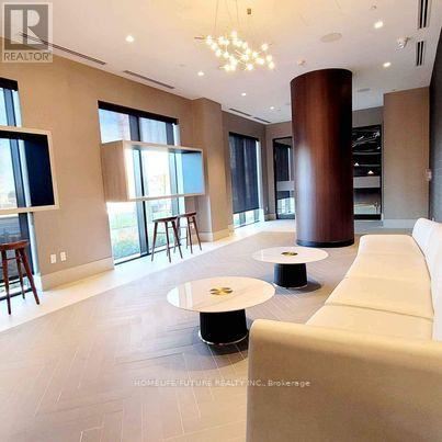 A modern living room with a white sofa and a round table.
