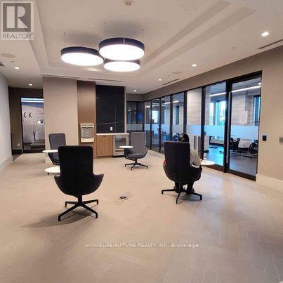 A spacious office with black chairs and a wooden cabinet.