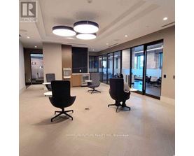 A spacious office with black chairs and a wooden cabinet.