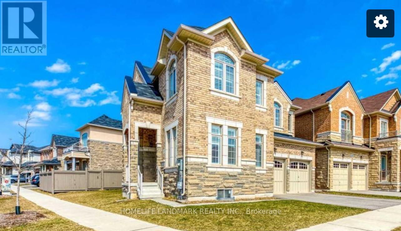 A large, well-maintained house with a stone facade and multiple garages is for sale.