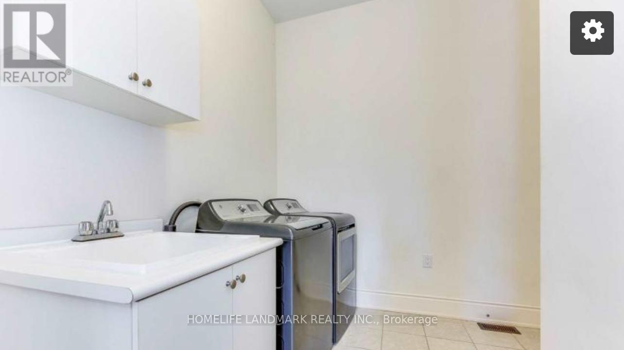 A white sink and microwave in a small kitchen.