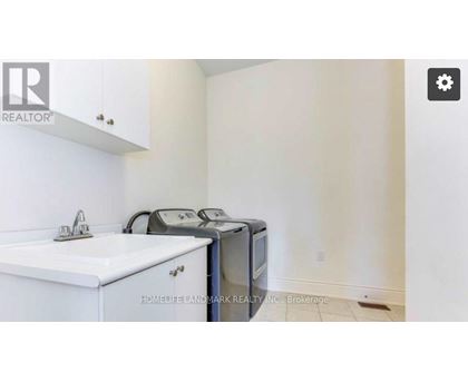 A white sink and microwave in a small kitchen.
