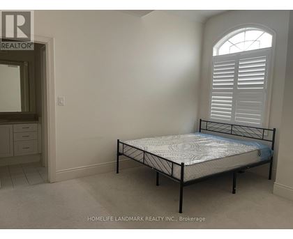 A bedroom with a bed, dresser, and window.