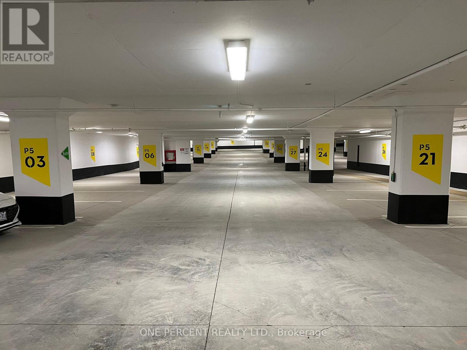 A parking garage with numbered parking spaces.
