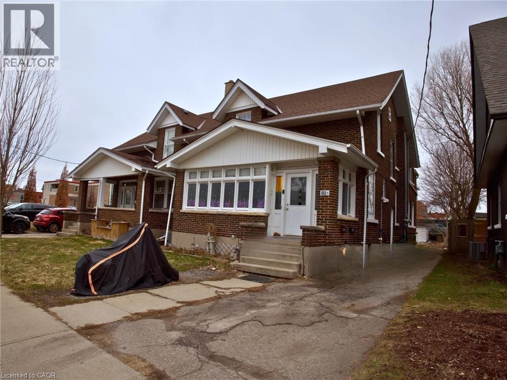 A house with a black tent in front of it.