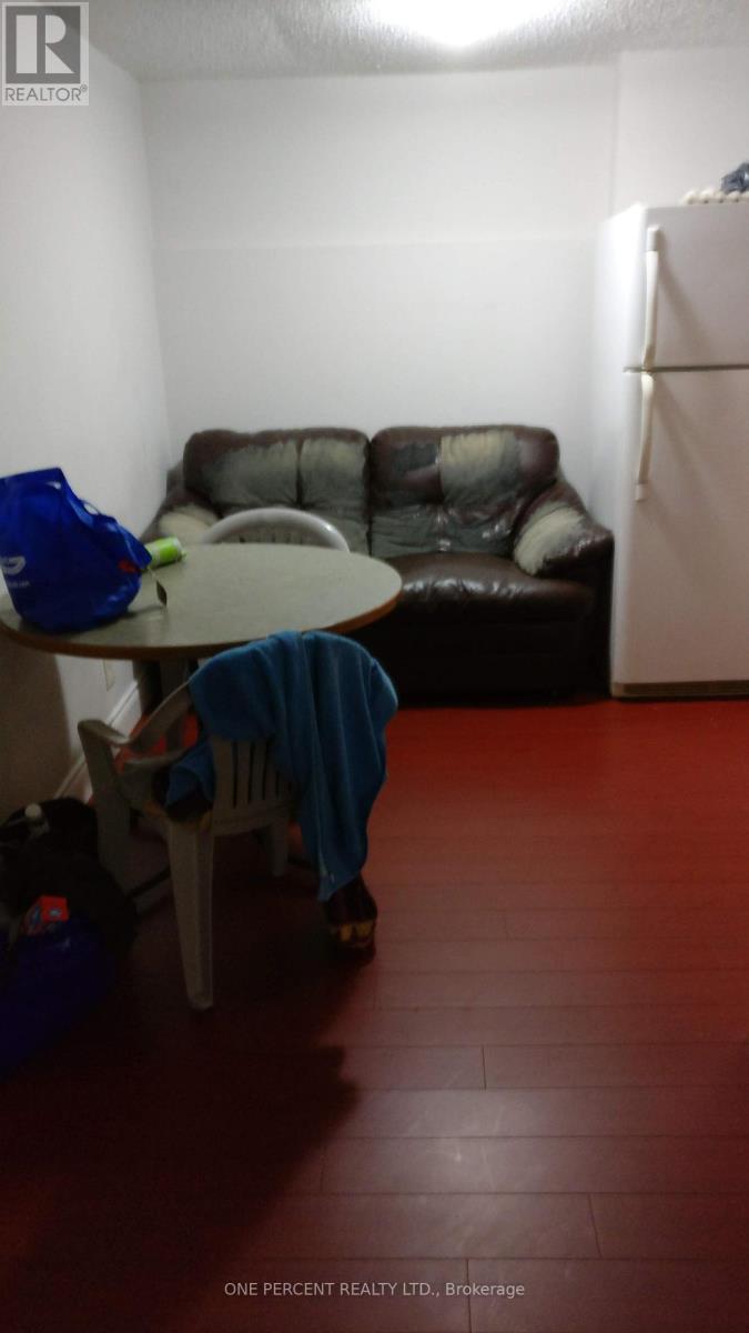 A living room with a brown couch and a blue chair.