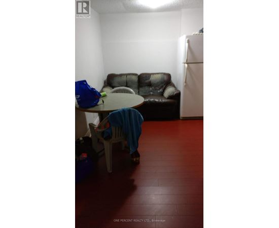 A living room with a brown couch and a blue chair.