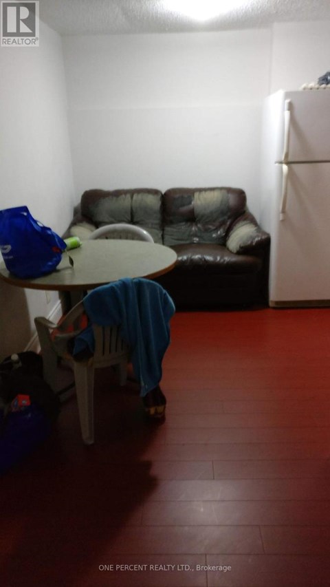 A living room with a brown couch and a blue chair.