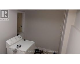 A white washing machine in a small laundry room.