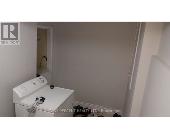 A white washing machine in a small laundry room.