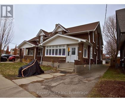 A house with a tent in front of it.