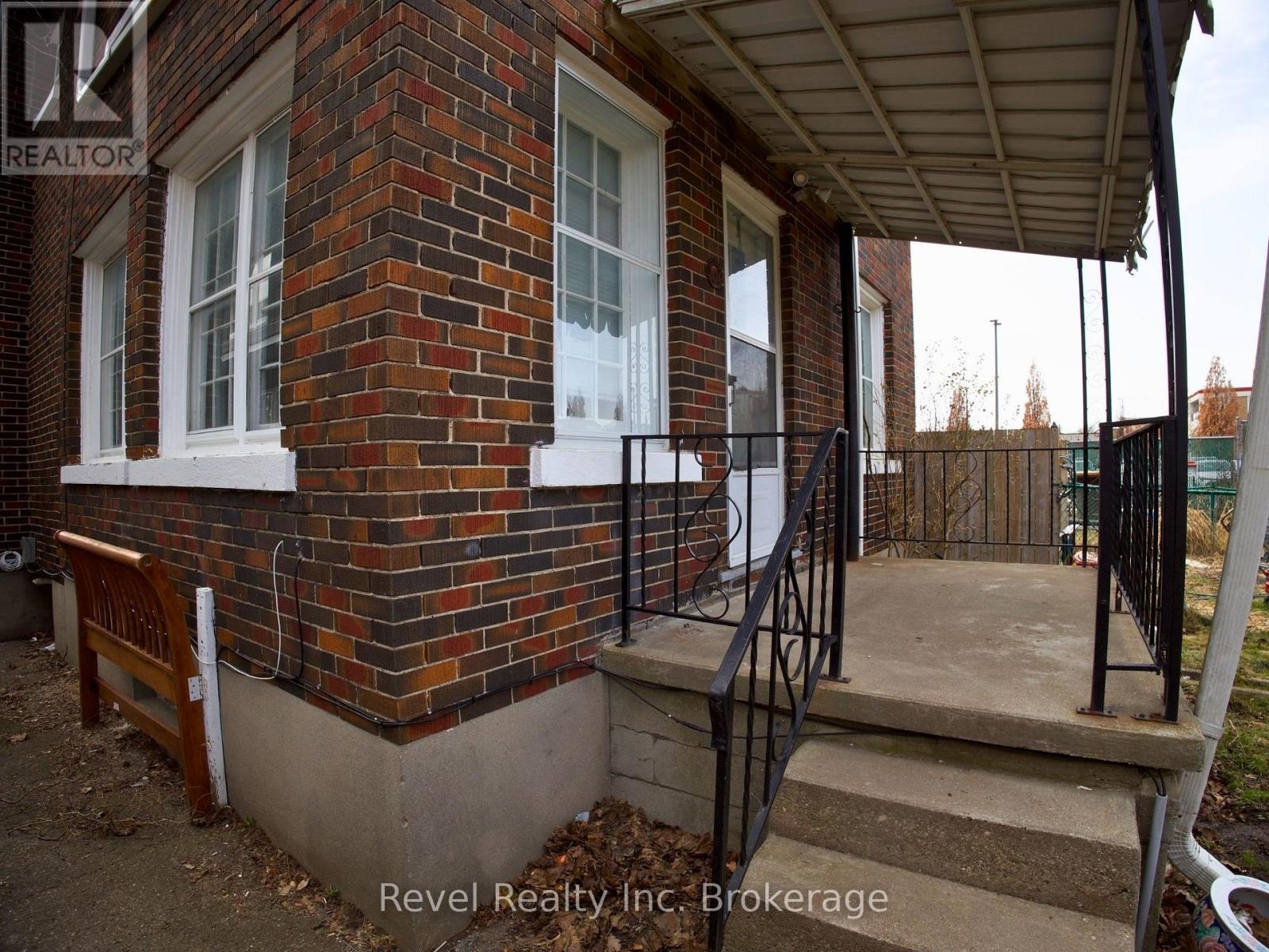 A house with a brick wall and a porch.