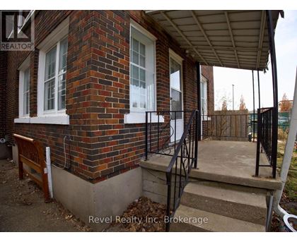 A house with a brick wall and a porch.