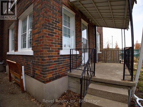 A house with a brick wall and a porch.