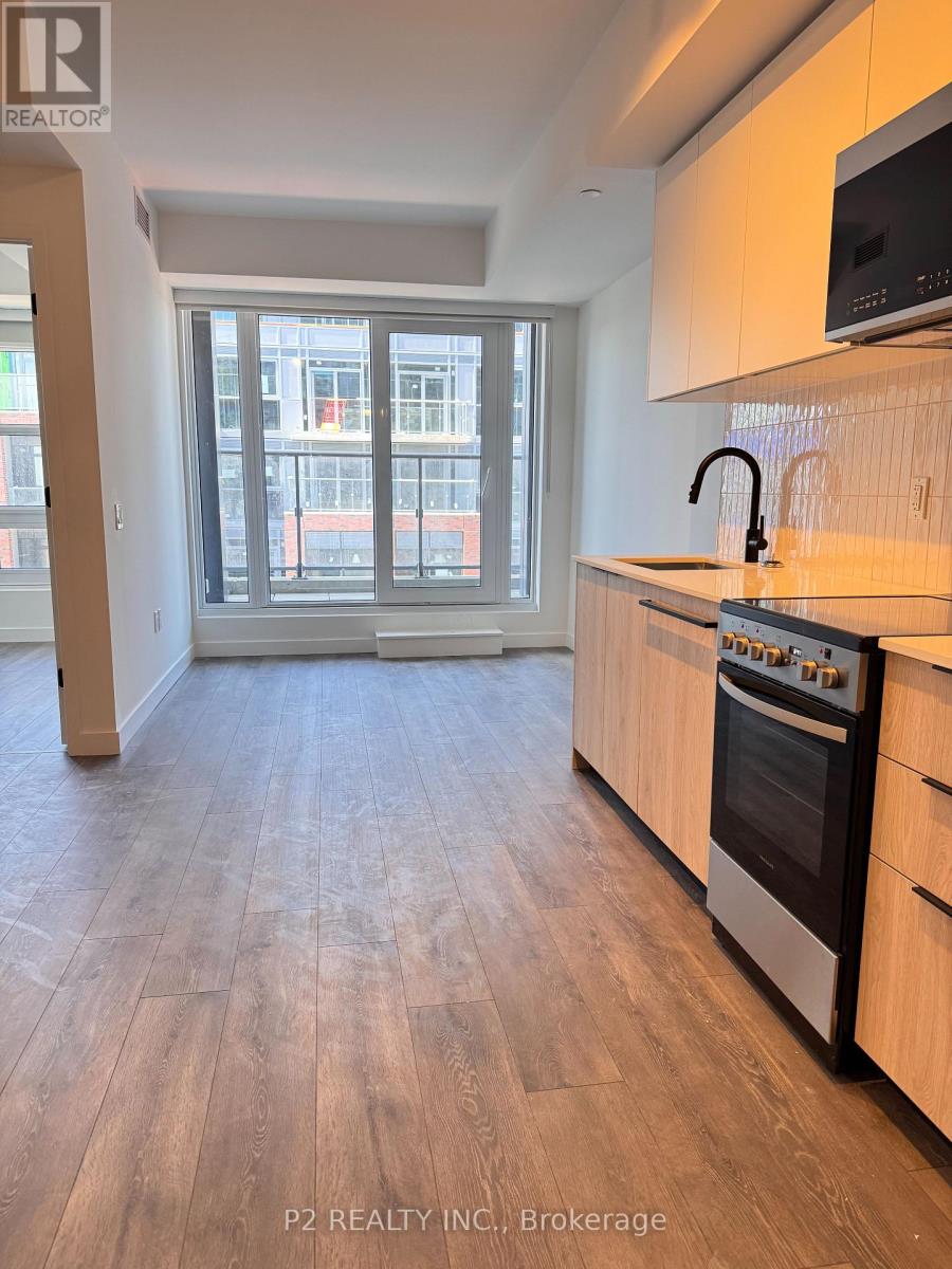 A kitchen with a stove top oven and a microwave on the counter.
