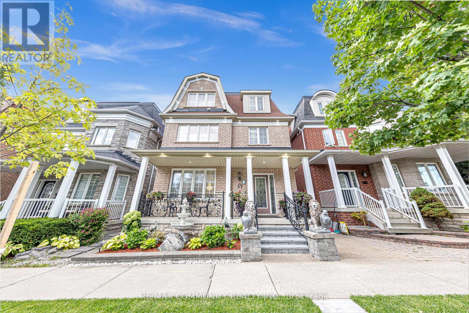 A large, well-maintained house with a front porch and multiple windows.