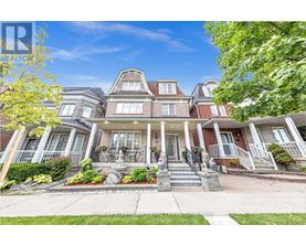 A large, well-maintained house with a front porch and multiple windows.