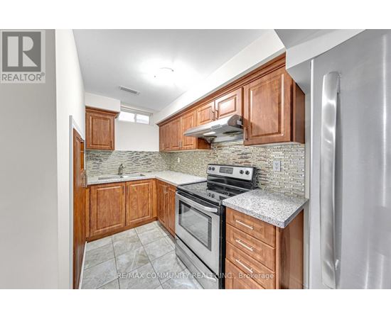 A kitchen with wooden cabinets and a granite countertop.
