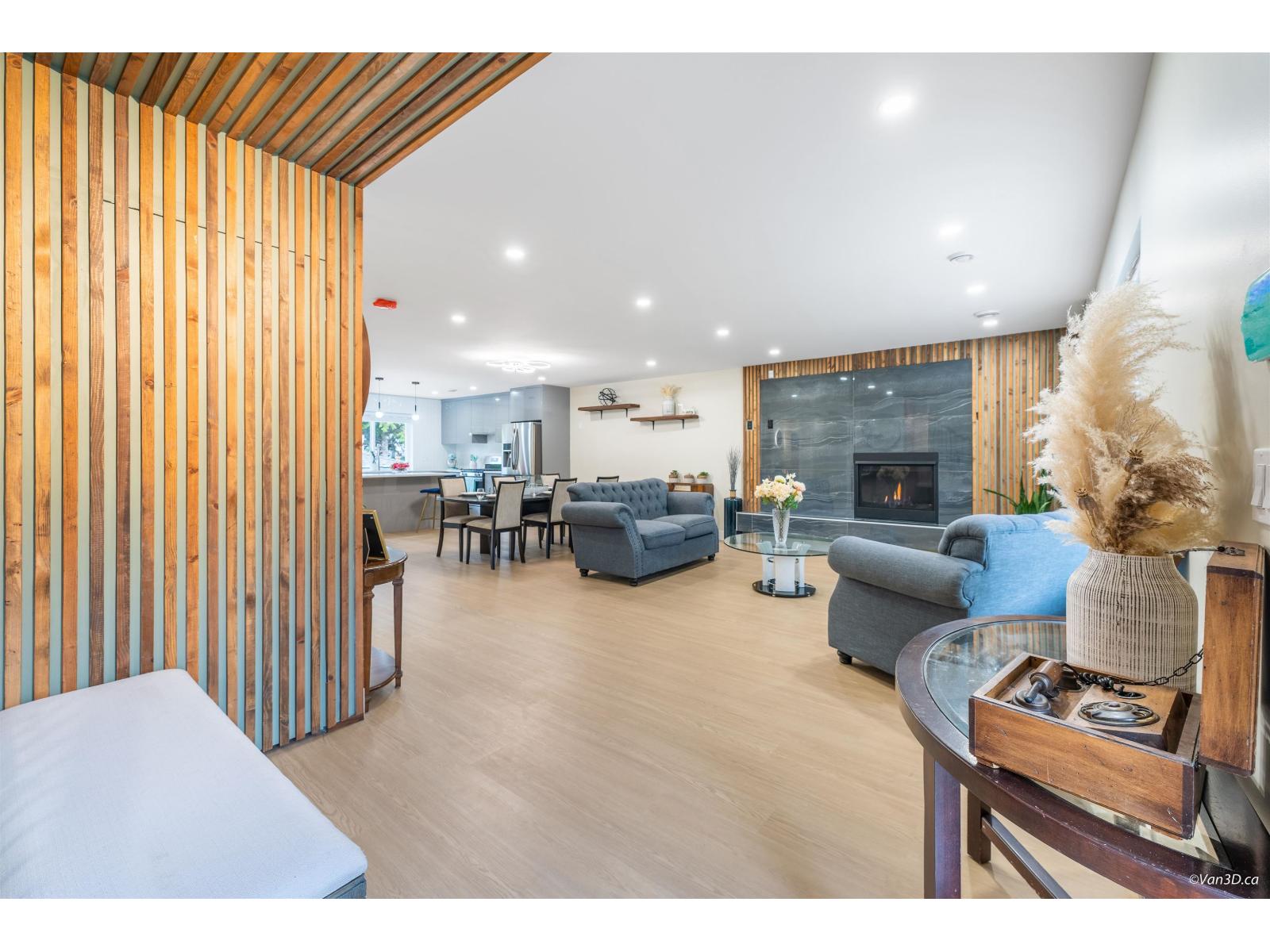 A modern living room with a fireplace and a dining area.
