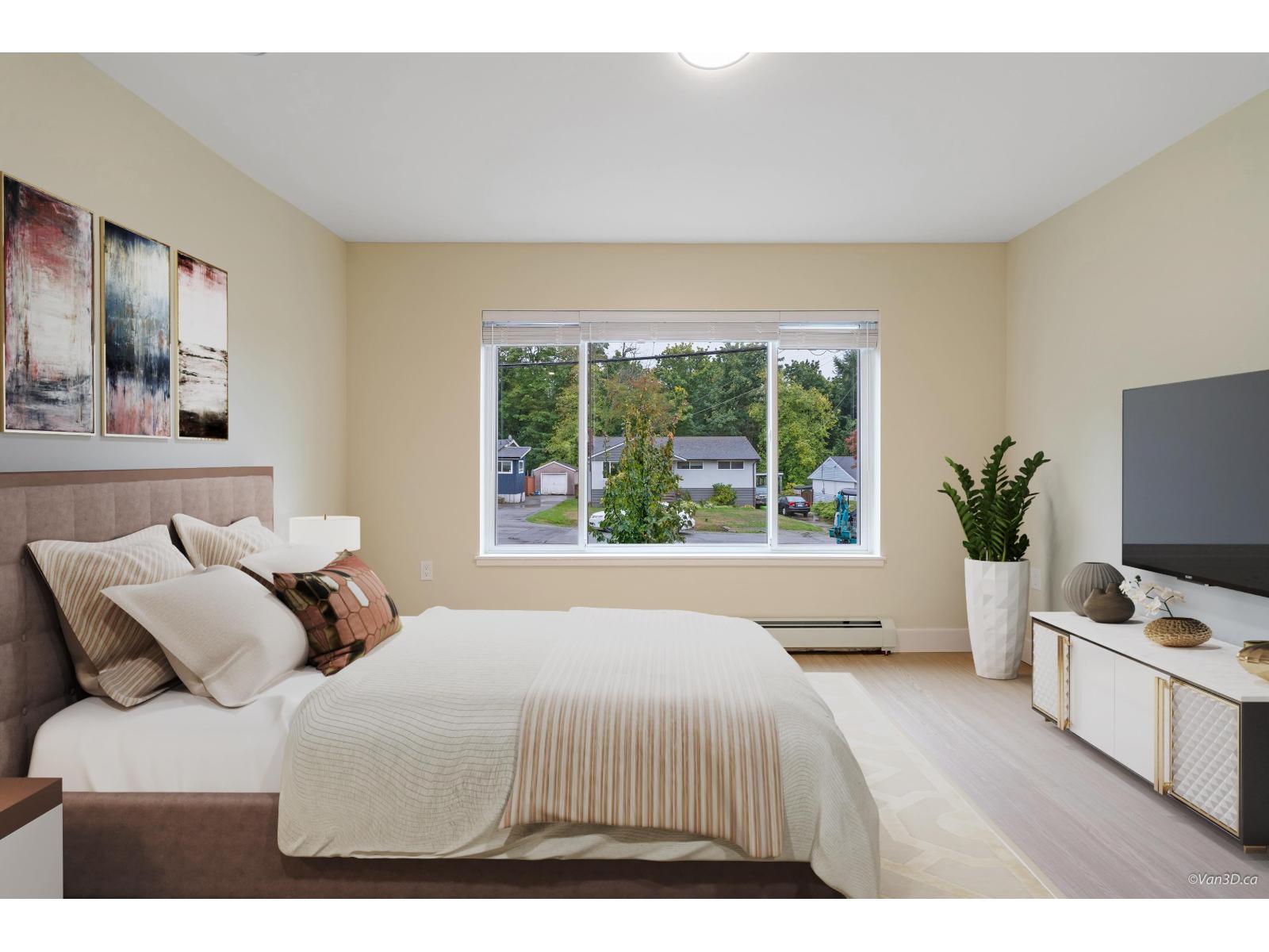 A bedroom with a large bed and a window overlooking a street.