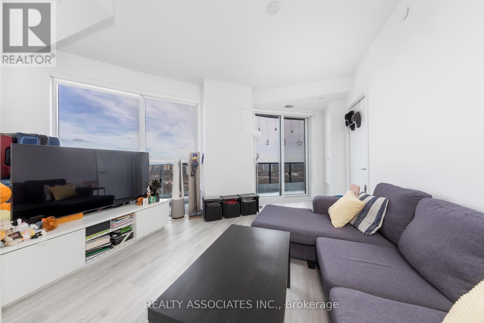 A living room with a grey couch and a television.