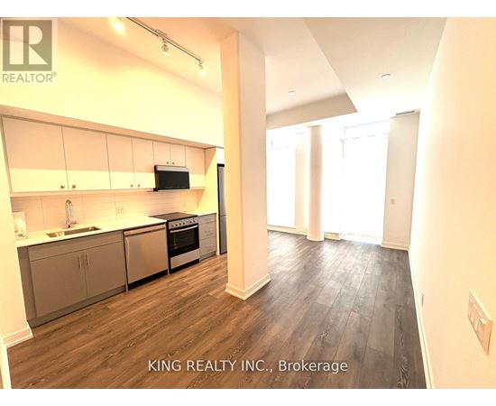 A kitchen with a stove top oven and a microwave built into the cabinetry.