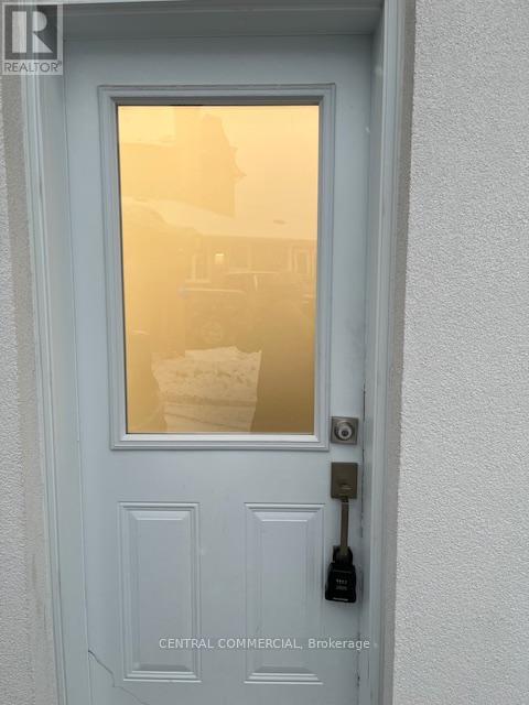 A white door with a glass window and a handle.