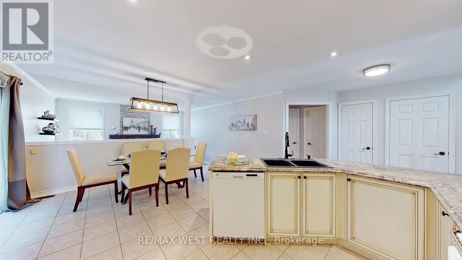 A well-lit kitchen with a dining table and chairs.