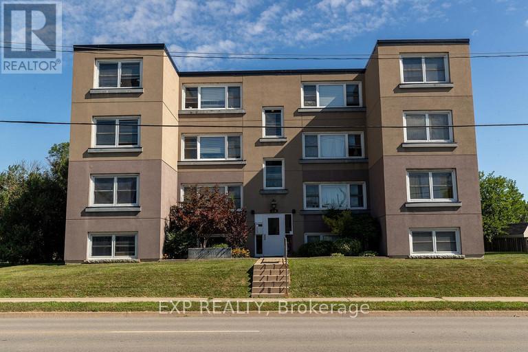 A large apartment building with a sign that says EXP REALTY Brokerage.