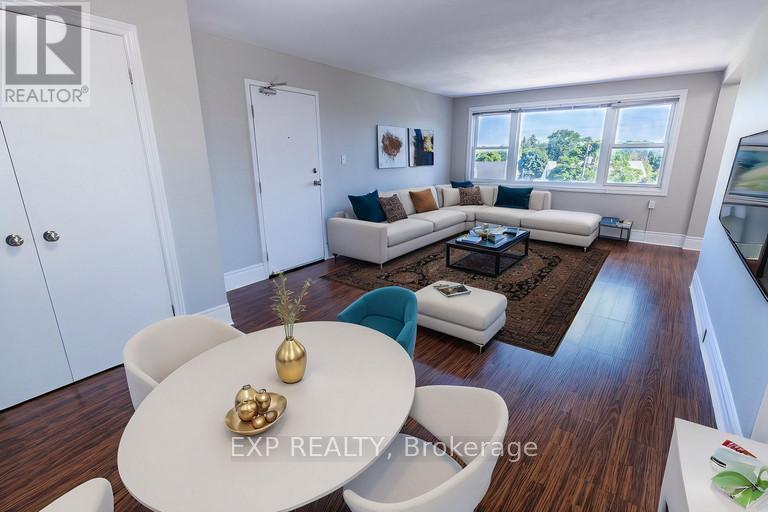 A well-lit living room with a white dining table and a white sofa.