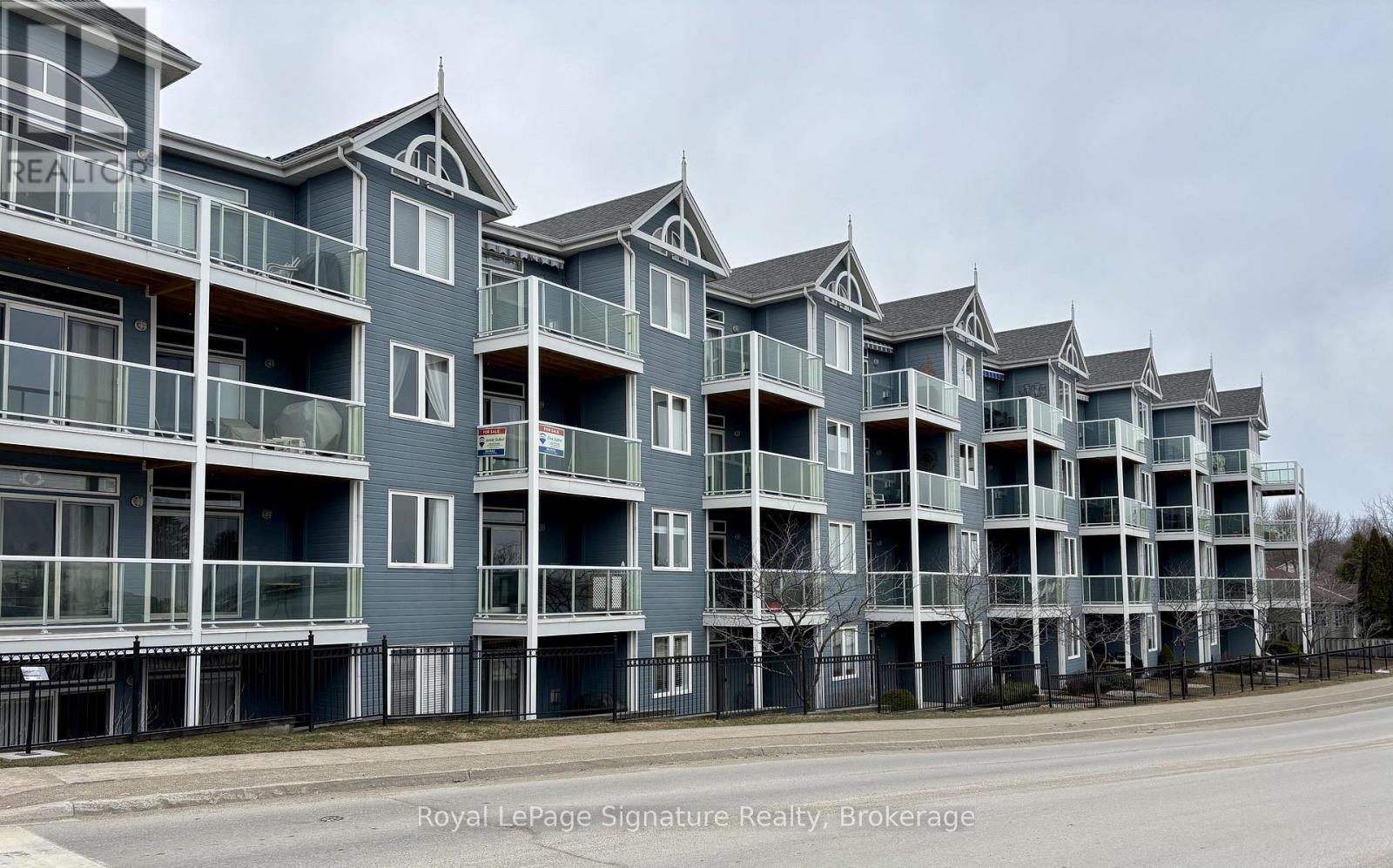 A row of apartment buildings with balconies and glass windows.