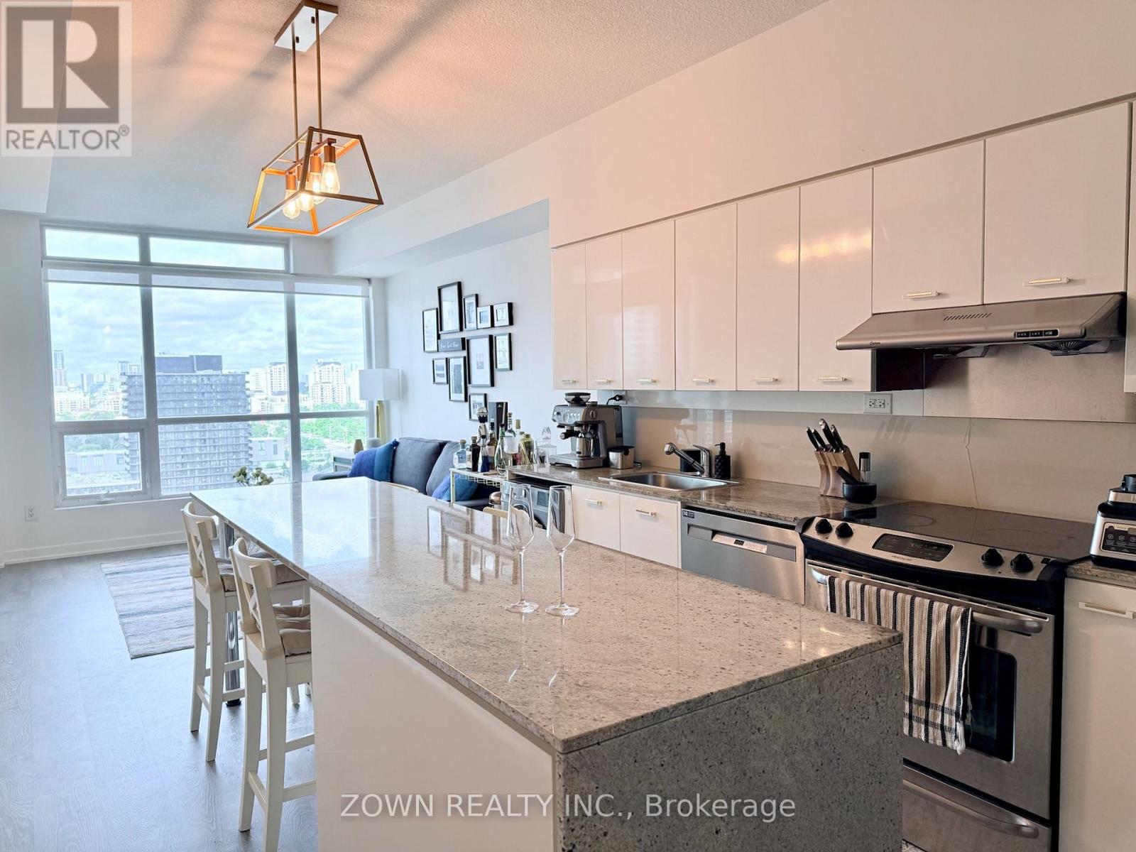 A kitchen with a large island and a view of the city.