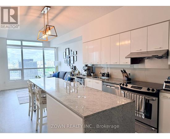 A kitchen with a large island and a view of the city.
