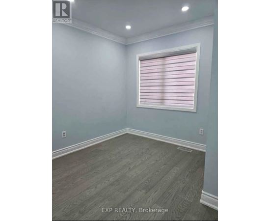 A room with a window covered in pink blinds.