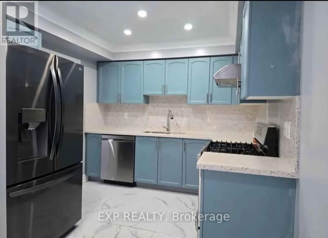 A kitchen with blue cabinets and a stainless steel refrigerator.