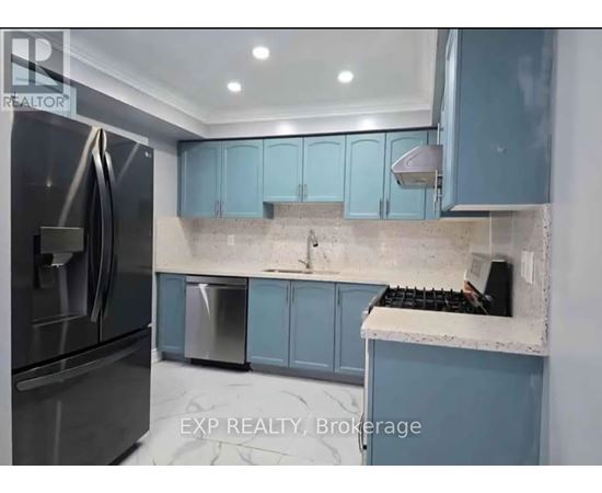 A kitchen with blue cabinets and a stainless steel refrigerator.