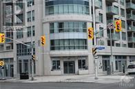 A building with the word "REAL" on it is behind a traffic light.