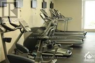 A row of treadmills are lined up in a gym.
