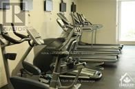 A row of treadmills are lined up in a gym.