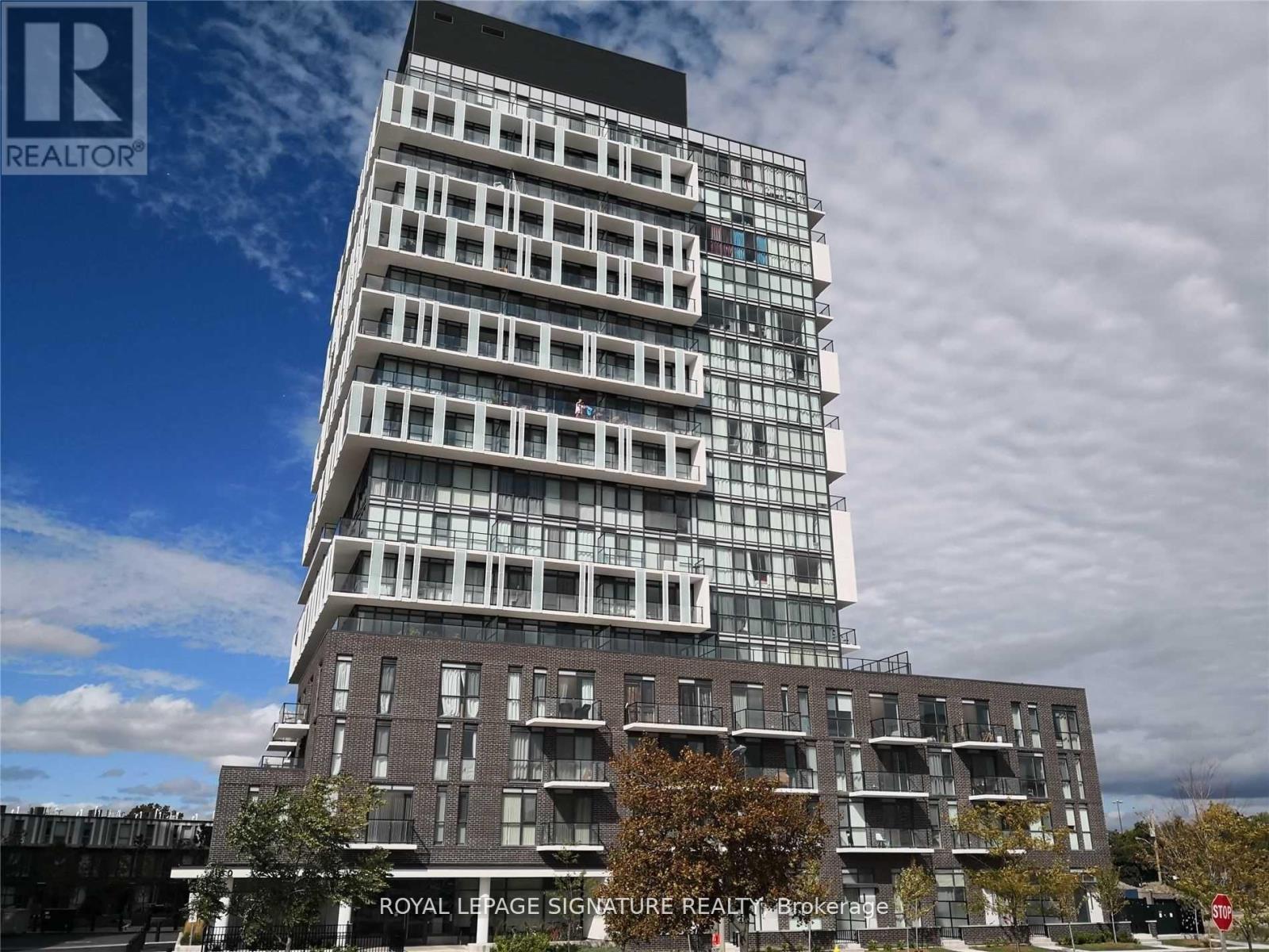 A tall building with a glass facade is the focus of this image.