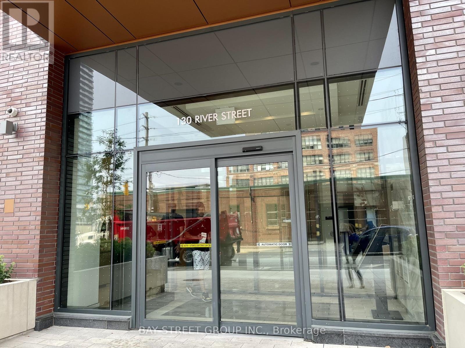 The entrance to a building with a glass door and a sign that reads "130 River Street".