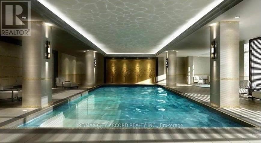 A large indoor swimming pool with a gold wall and a white ceiling.