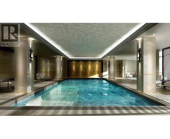 A large indoor swimming pool with a gold wall and a white ceiling.