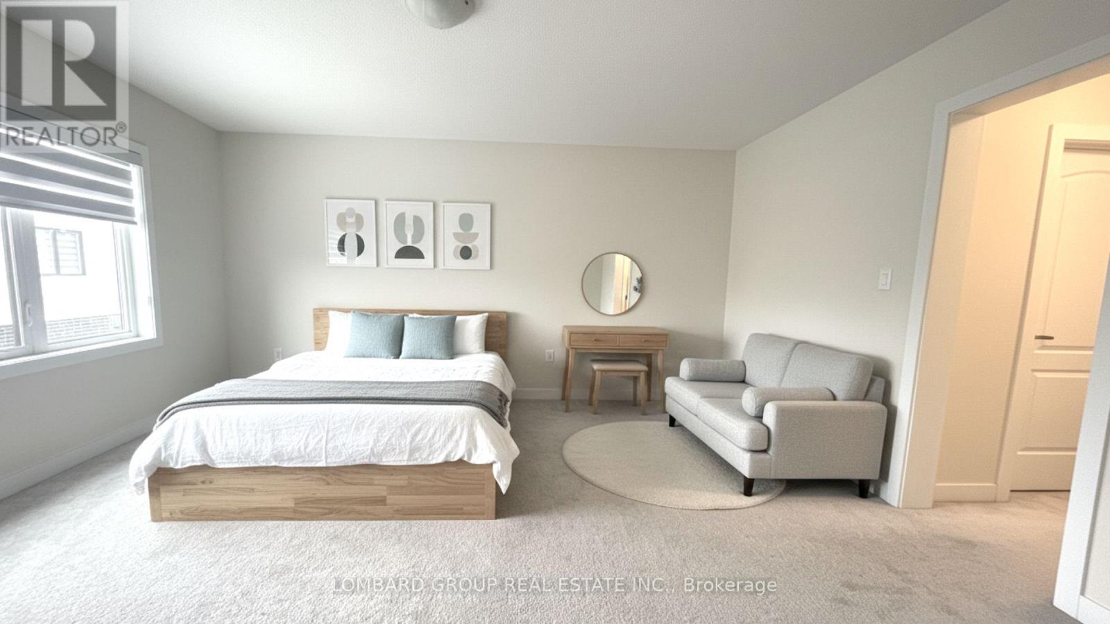 A bedroom with a bed, a couch, and a table.