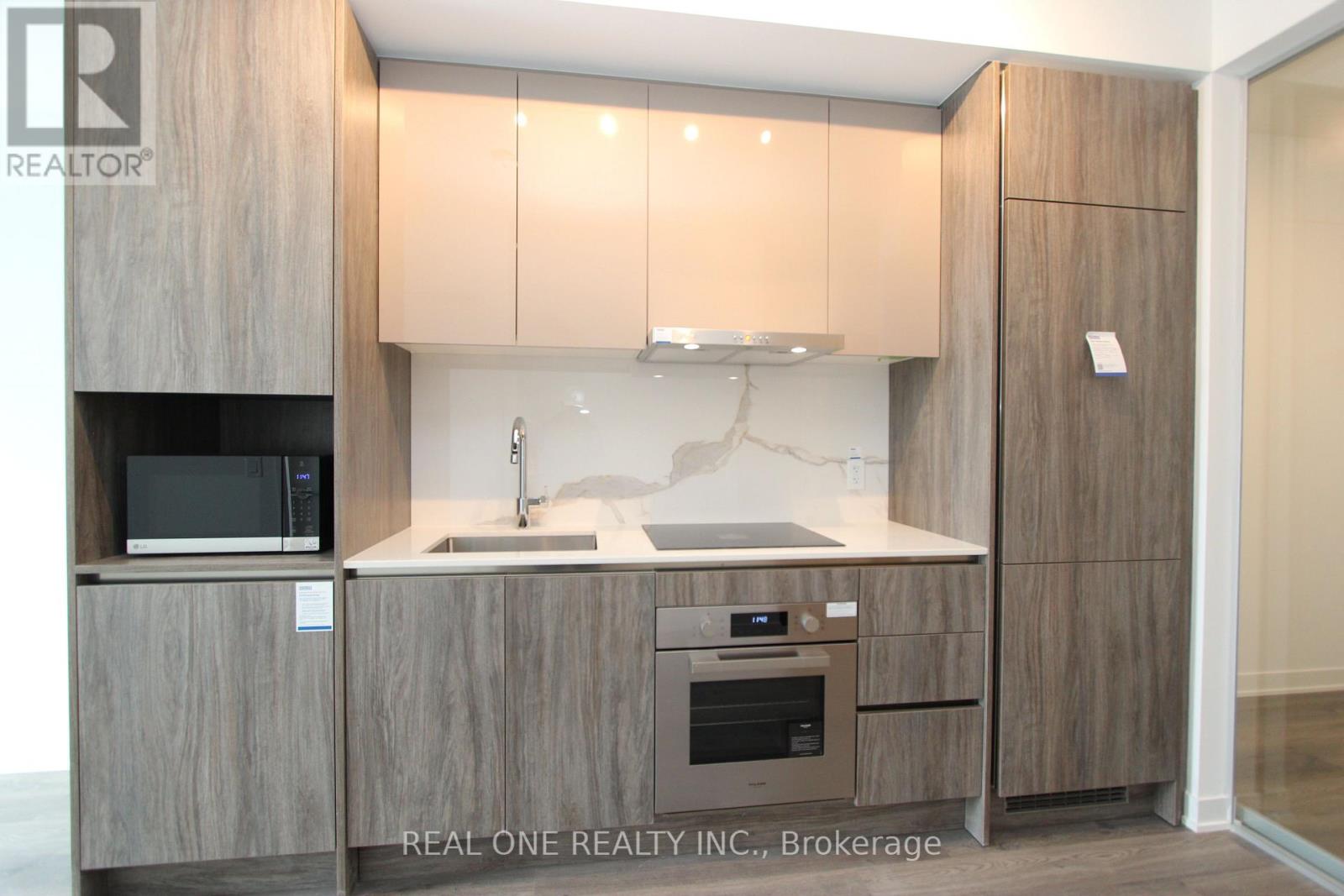 A modern kitchen with wooden cabinets and appliances.