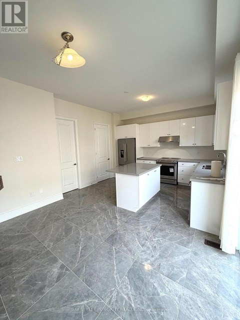 A kitchen with a marble floor and white walls.