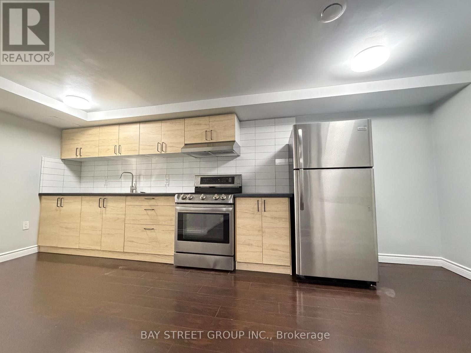 A kitchen with wooden cabinets and stainless steel appliances.